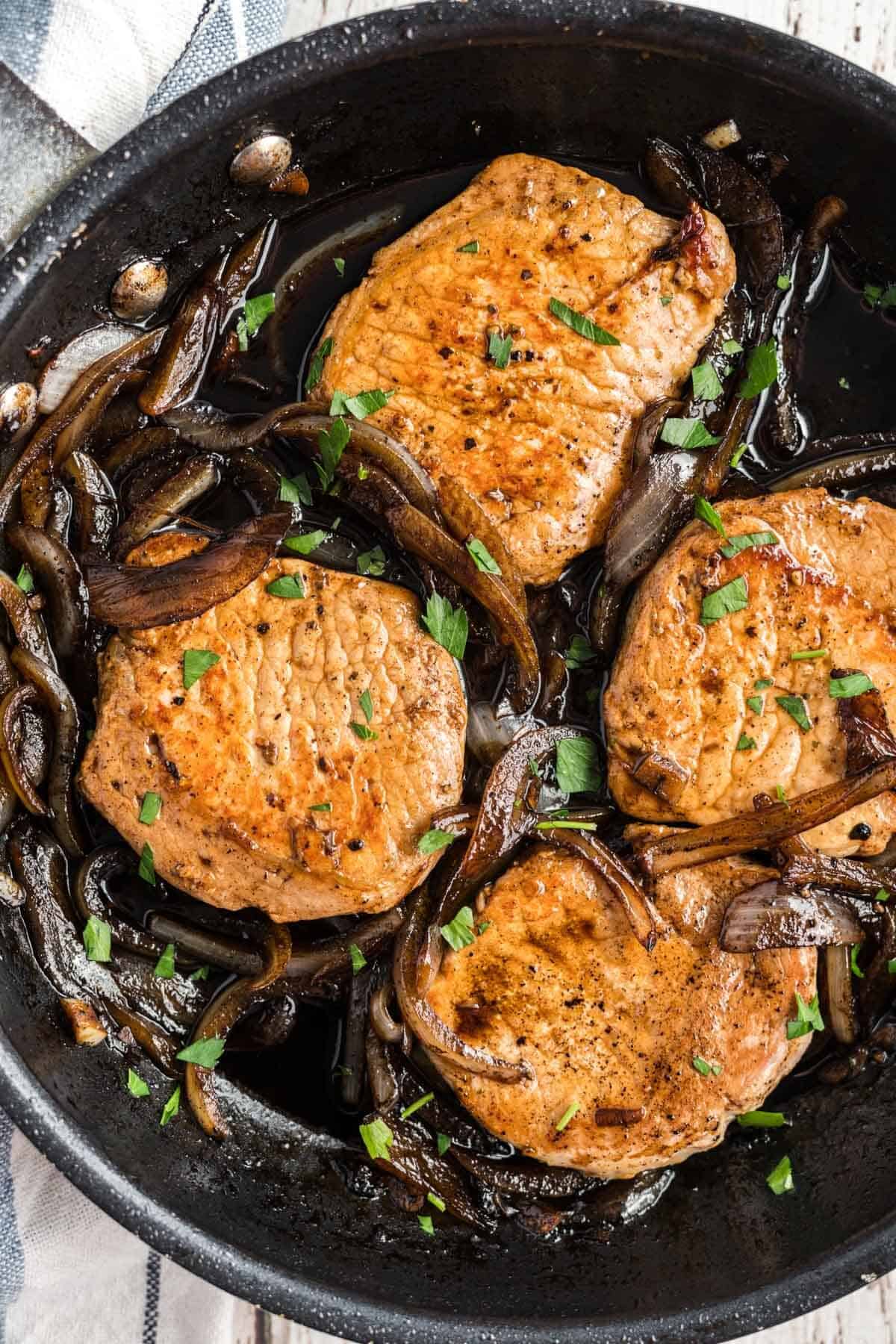 pork chops in a cast iron skillet