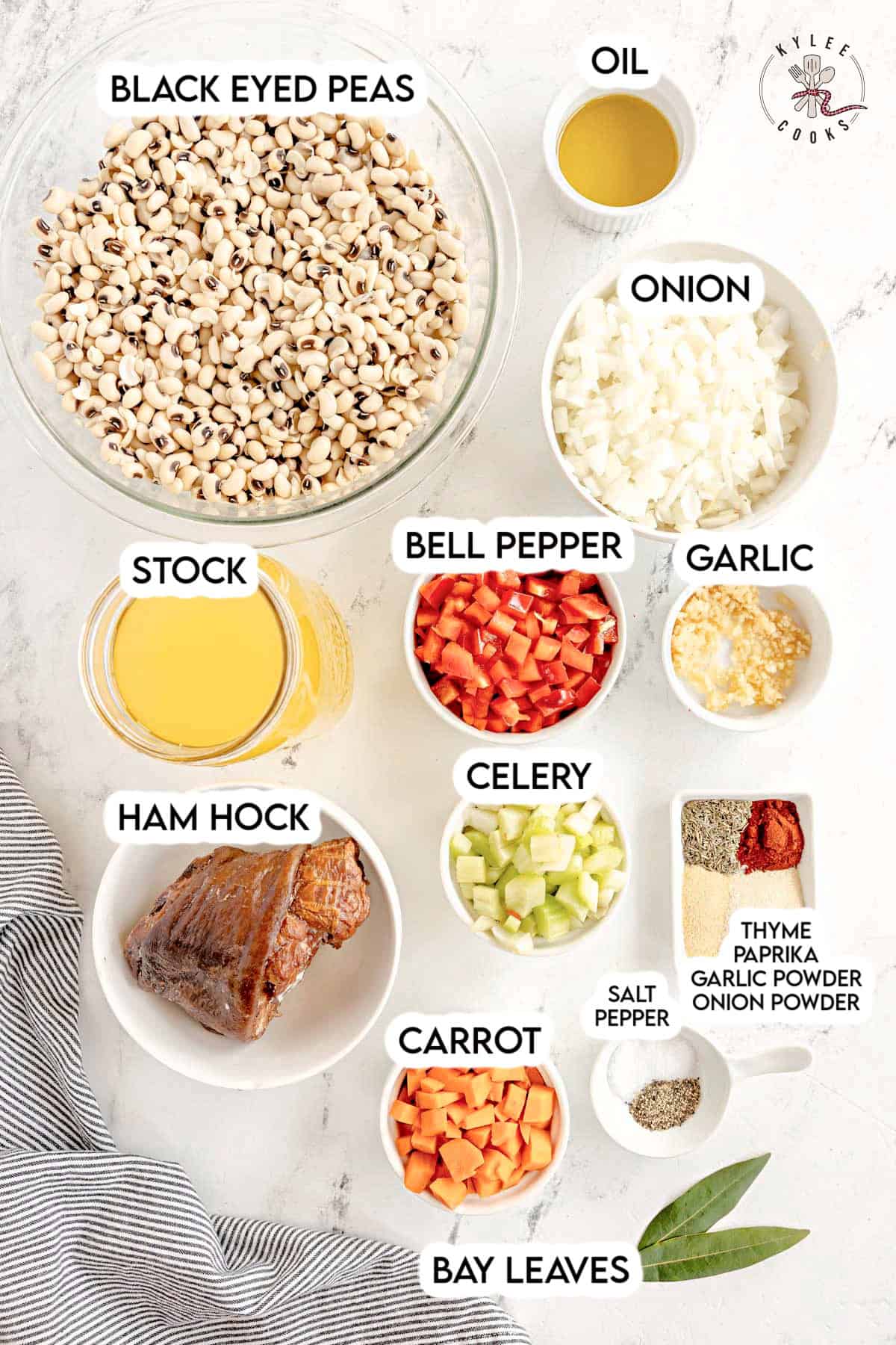 Ingredients for a hearty Black-Eyed Pea Soup: black-eyed peas, oil, onion, stock, bell pepper, garlic, ham hock, celery, carrot, spices, and bay leaves.