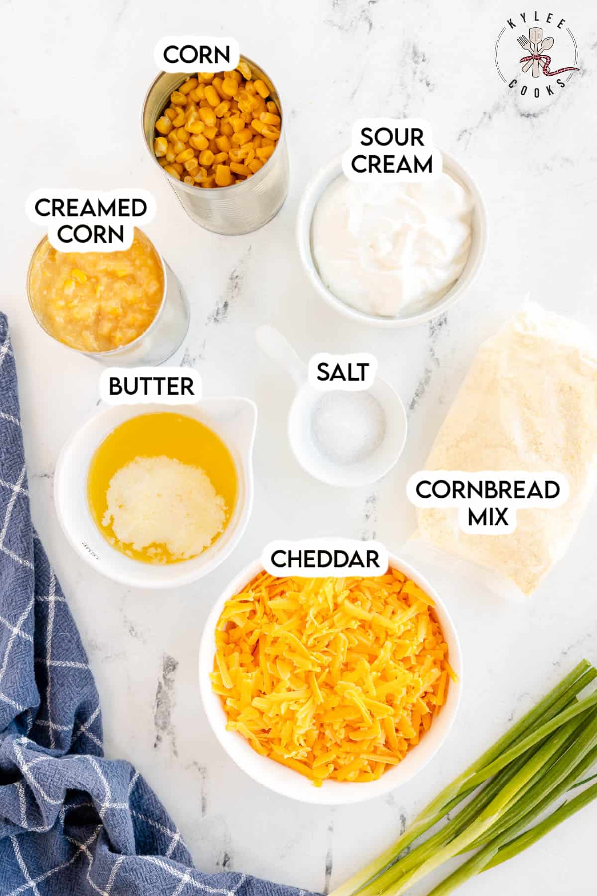 ingredients to make corn casserole laid out and labeled.