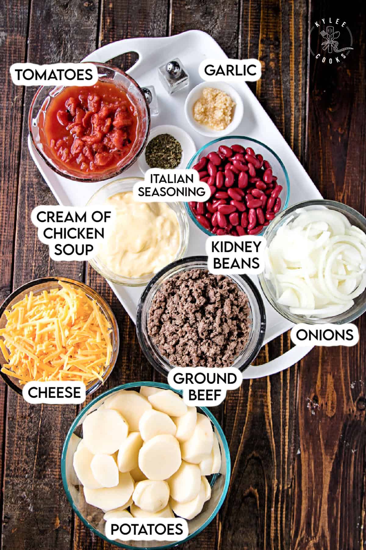 ingredients to make cowboy casserole laid out on a wooden board with a white tray