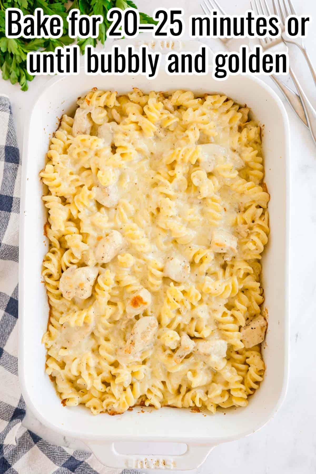 Baked chicken Alfredo pasta with golden, melted cheese on top. Text on the image says 'Bake for 20–25 minutes or until bubbly and golden'.