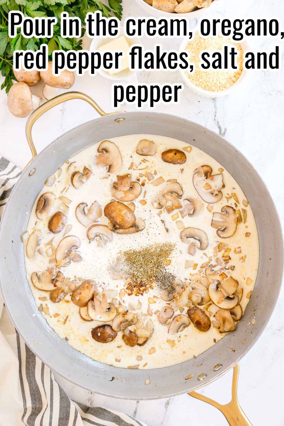 Skillet filled with cream, mushrooms, and seasoning. Text on the image says 'Pour in the cream, oregano, red pepper flakes, salt and pepper'.