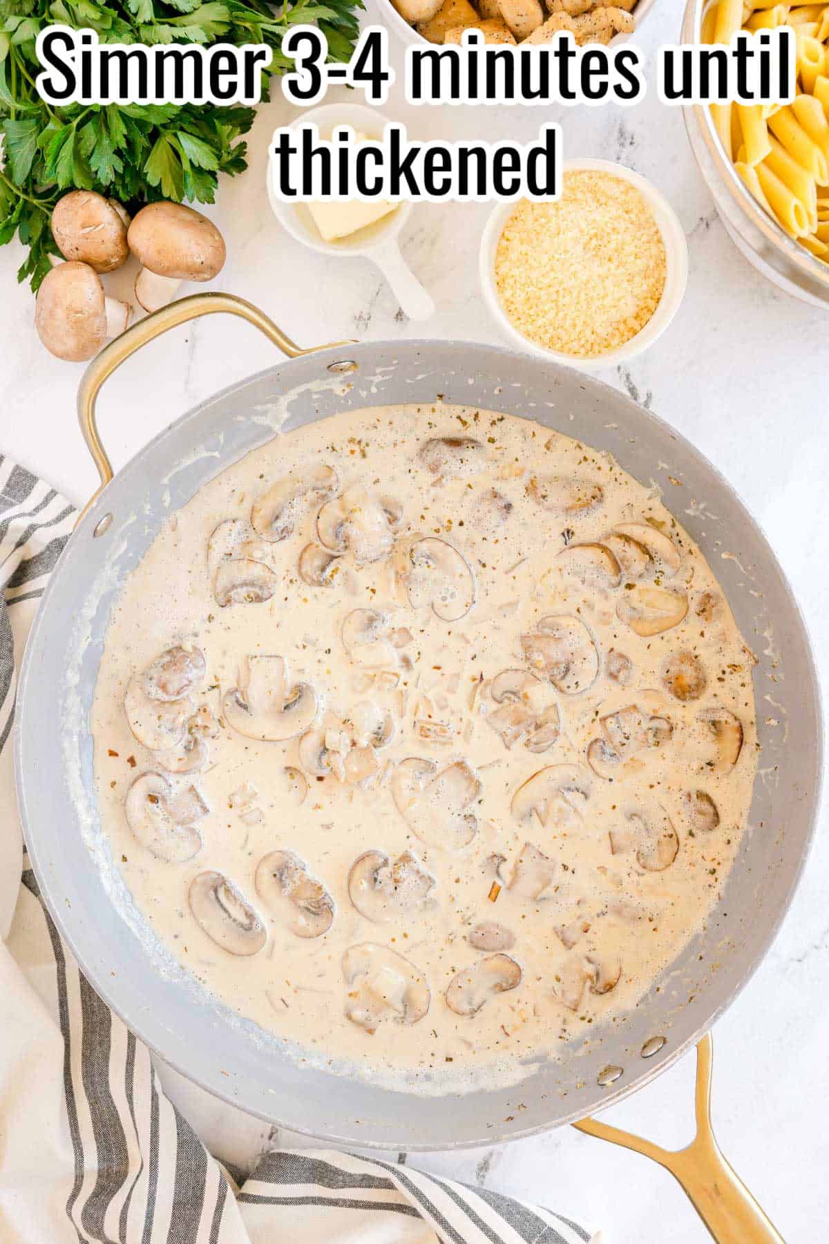 Mushroom cream sauce simmering in a skillet. Text on the image says 'Simmer 3–4 minutes until thickened'.