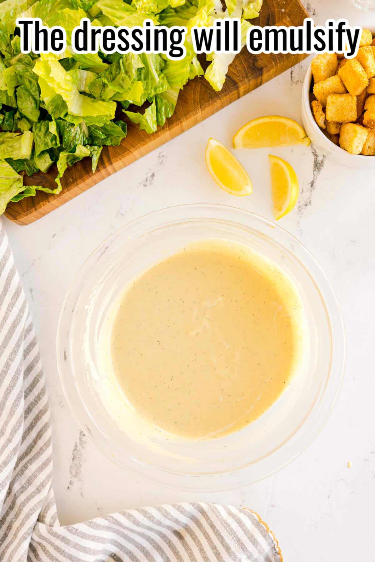 A bowl of finished creamy dressing. Text on the image says 'The dressing will emulsify'.