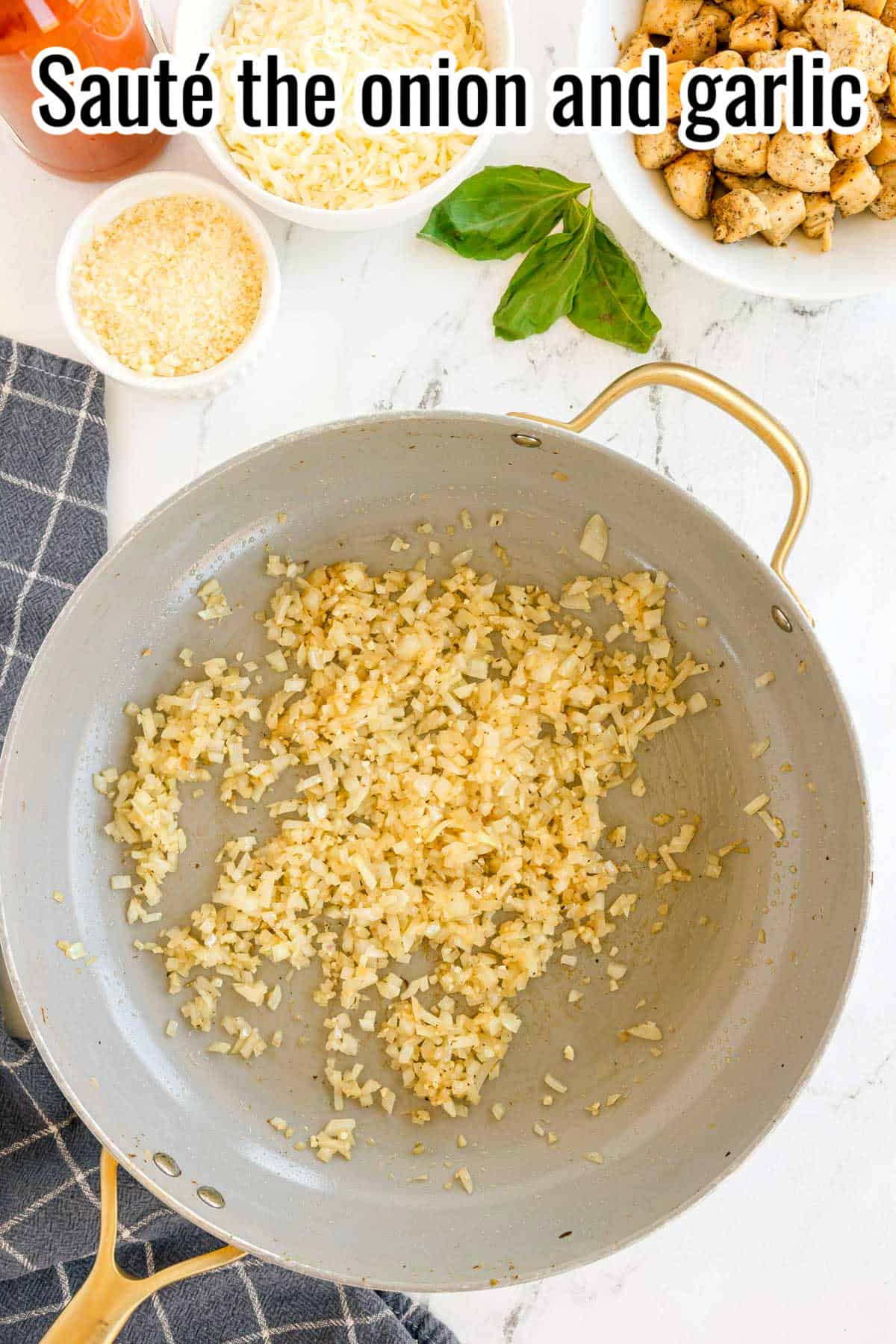 A skillet with sautéed diced onion and garlic. Text on the image says 'Sauté the onion and garlic'.