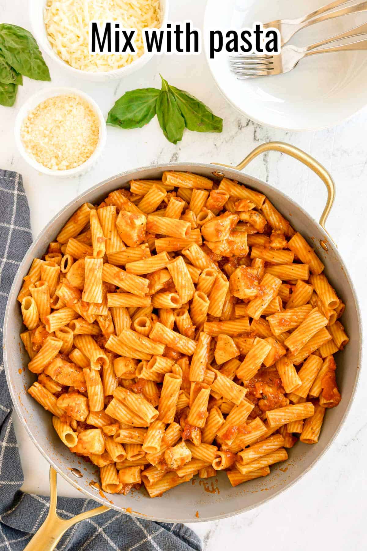 A skillet of rigatoni and chicken in marinara sauce. Text on the image says 'Mix with pasta'.