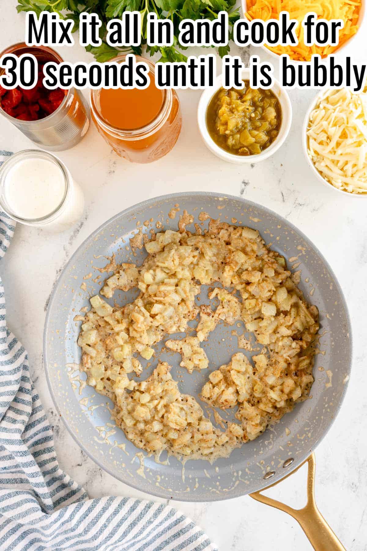 A frying pan with chicken and spaghetti ingredients, as well as text that reads mix all in and cook for 30 seconds until it is bubbly.