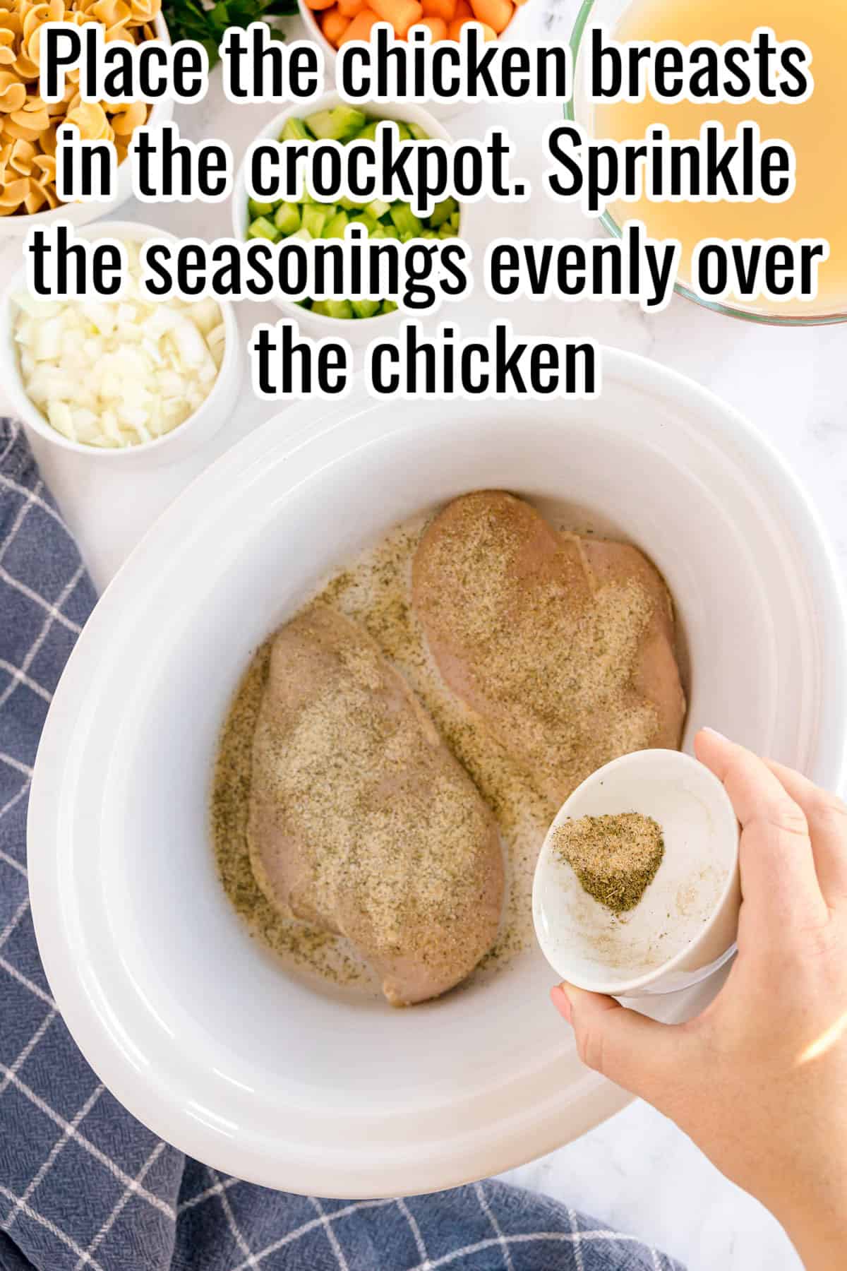Chicken breasts in a slow cooker with seasoning being sprinkled over them. Text on the image says 'Place the chicken breasts in the crockpot. Sprinkle the seasonings evenly over the chicken'.