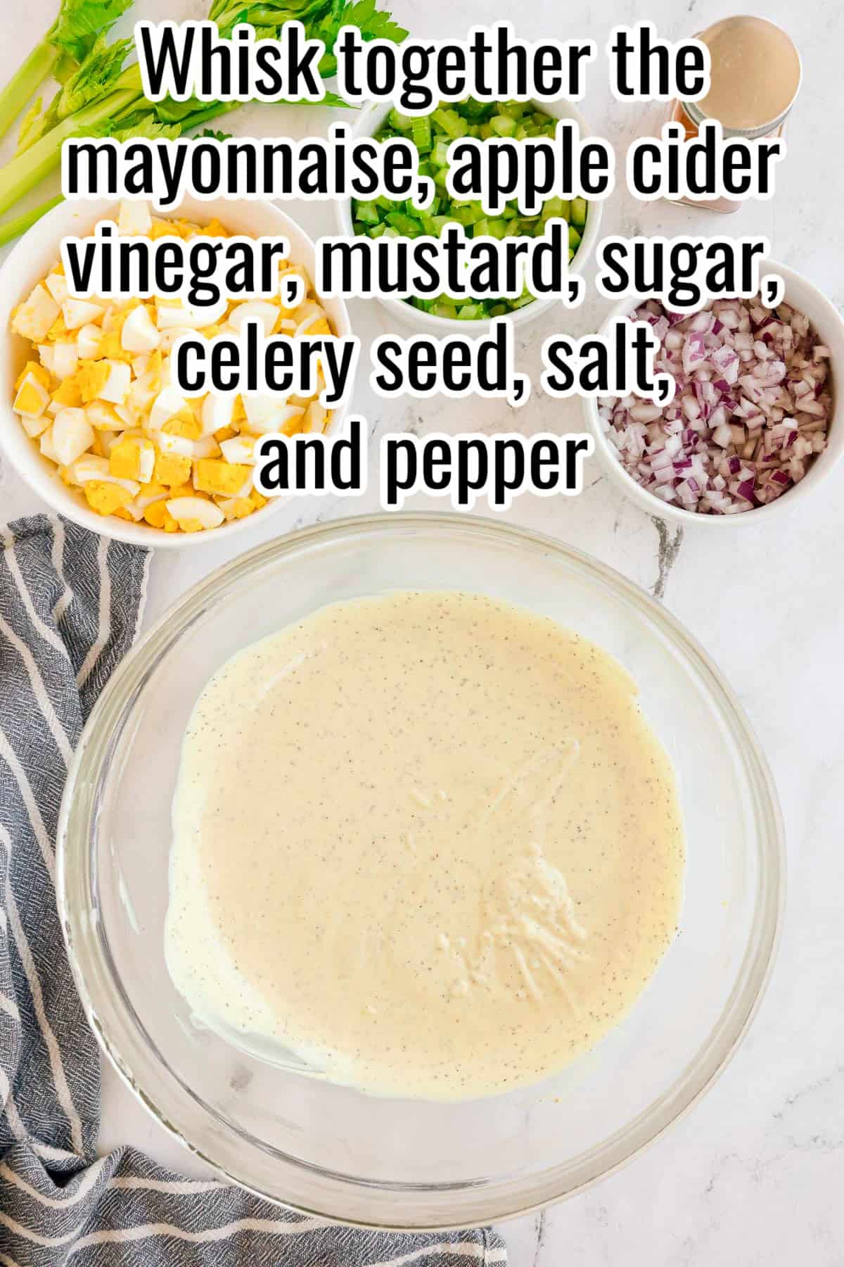 A bowl of dressing with bowls of chopped eggs, celery, and red onion nearby. Text on the image says 'Whisk together the mayonnaise, apple cider vinegar, mustard, sugar, celery seed, salt, and pepper'.