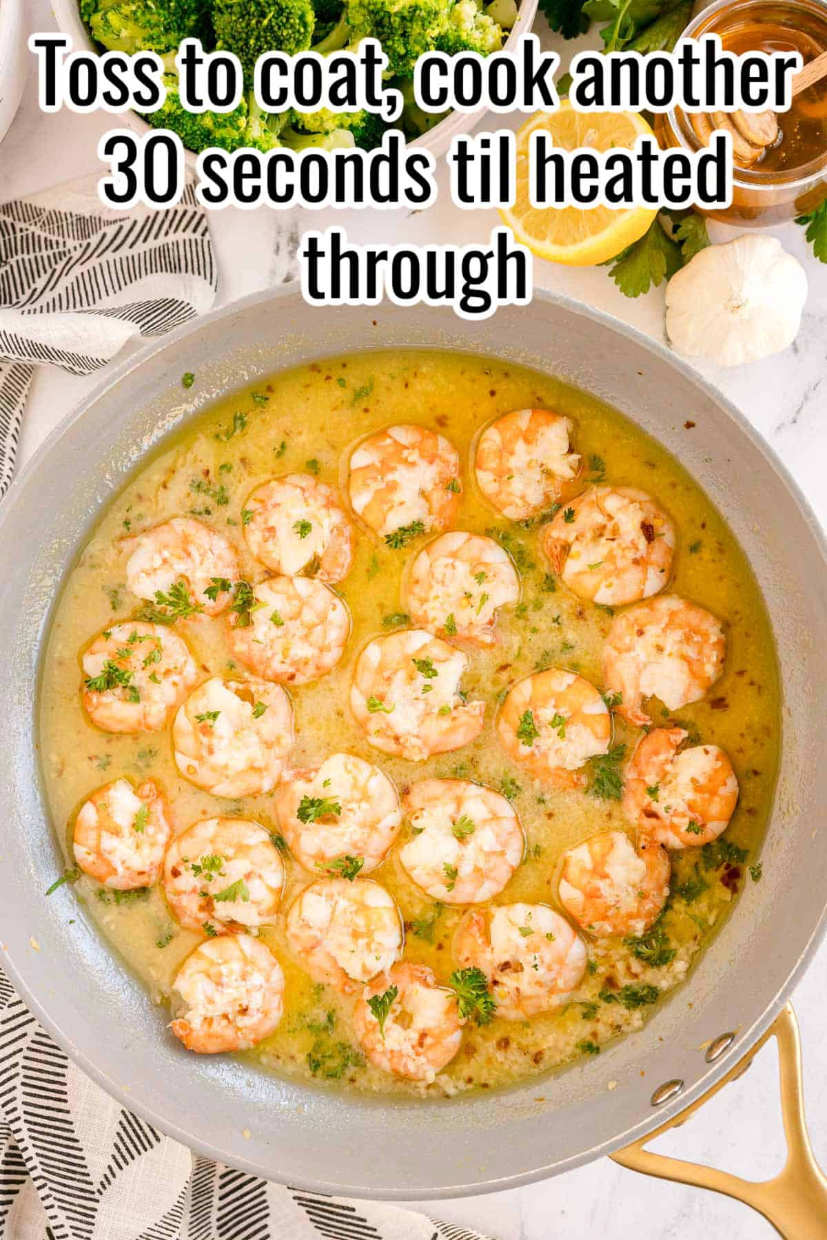 Shrimp in a golden sauce, sprinkled with chopped parsley. Text on the image says 'Toss to coat, cook another 30 seconds til heated through'.
