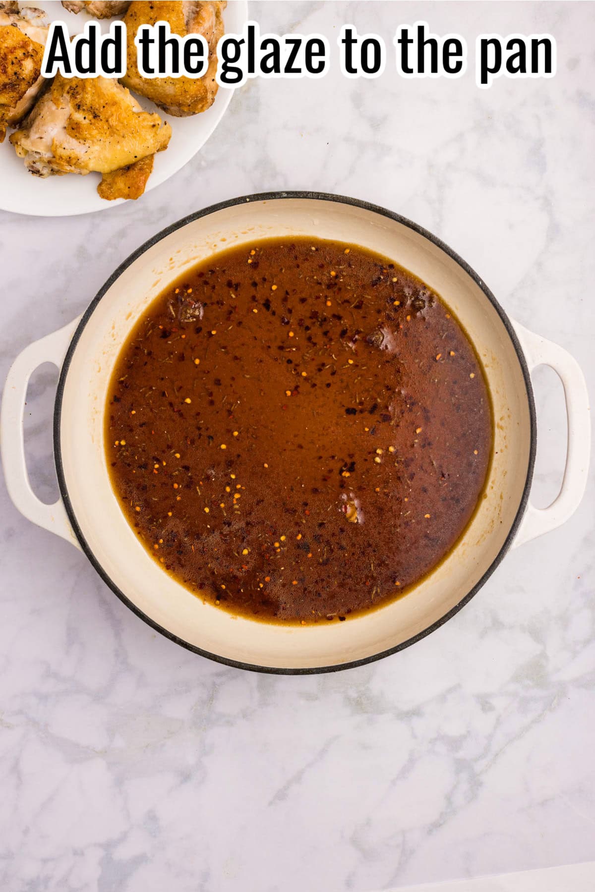 A skillet filled with dark glaze sauce and red pepper flakes. Text on the image says 'Add the glaze to the pan'.
