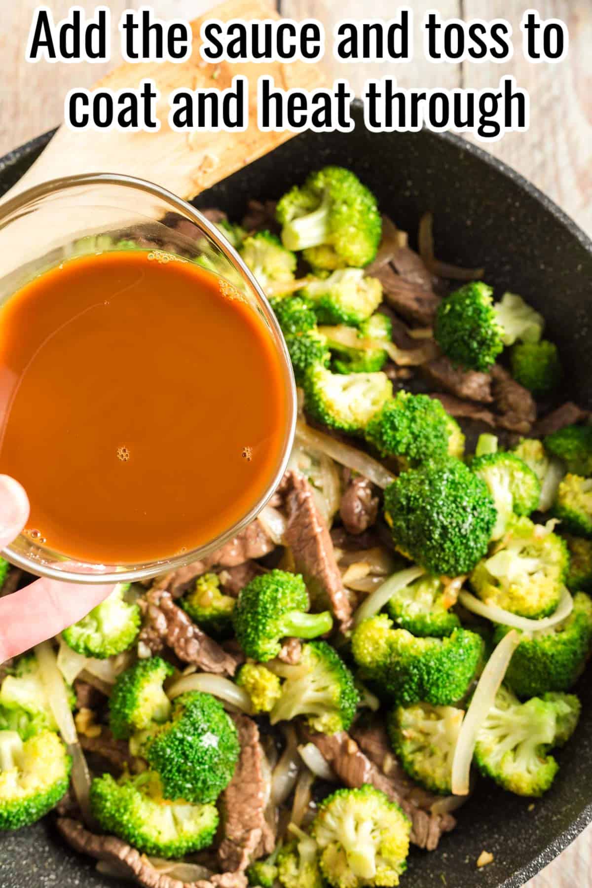 A hand pouring the soy sauce mixture into the skillet with beef and broccoli. Text on the image says 'Add the sauce and toss to coat and heat through'.