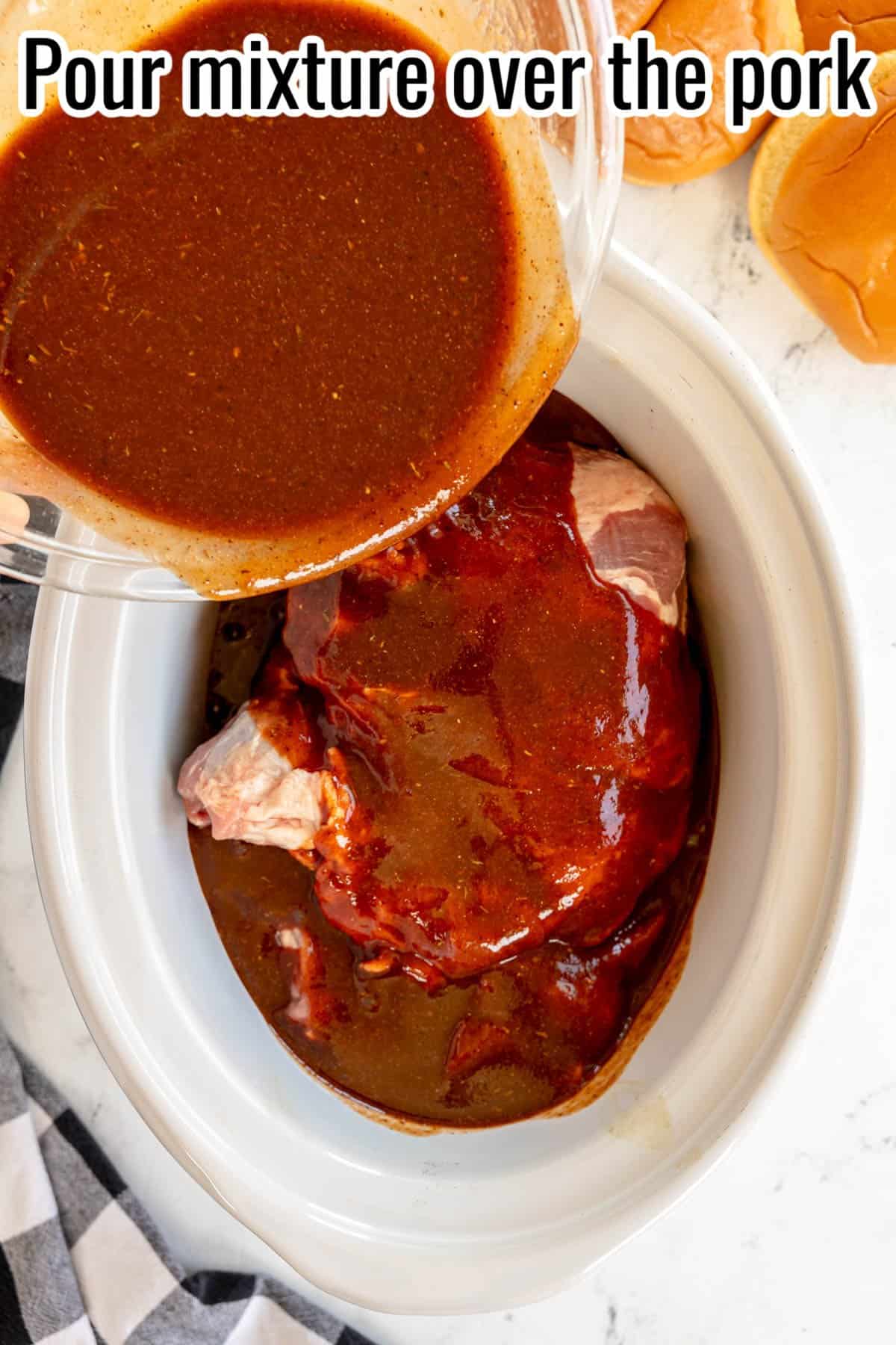 A bowl of seasoned sauce is being poured over a piece of raw pork in a white slow cooker, with the text "Pour mixture over the pork" at the top.
