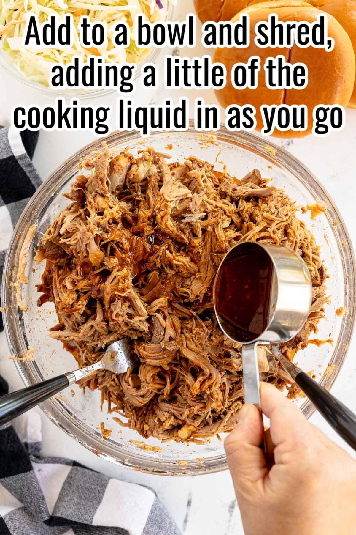 A hand is pouring cooking liquid into a bowl of shredded meat, with tongs and a fork mixed into the food. The text says "Add to a bowl and shred, adding a little of the cooking liquid in as you go.