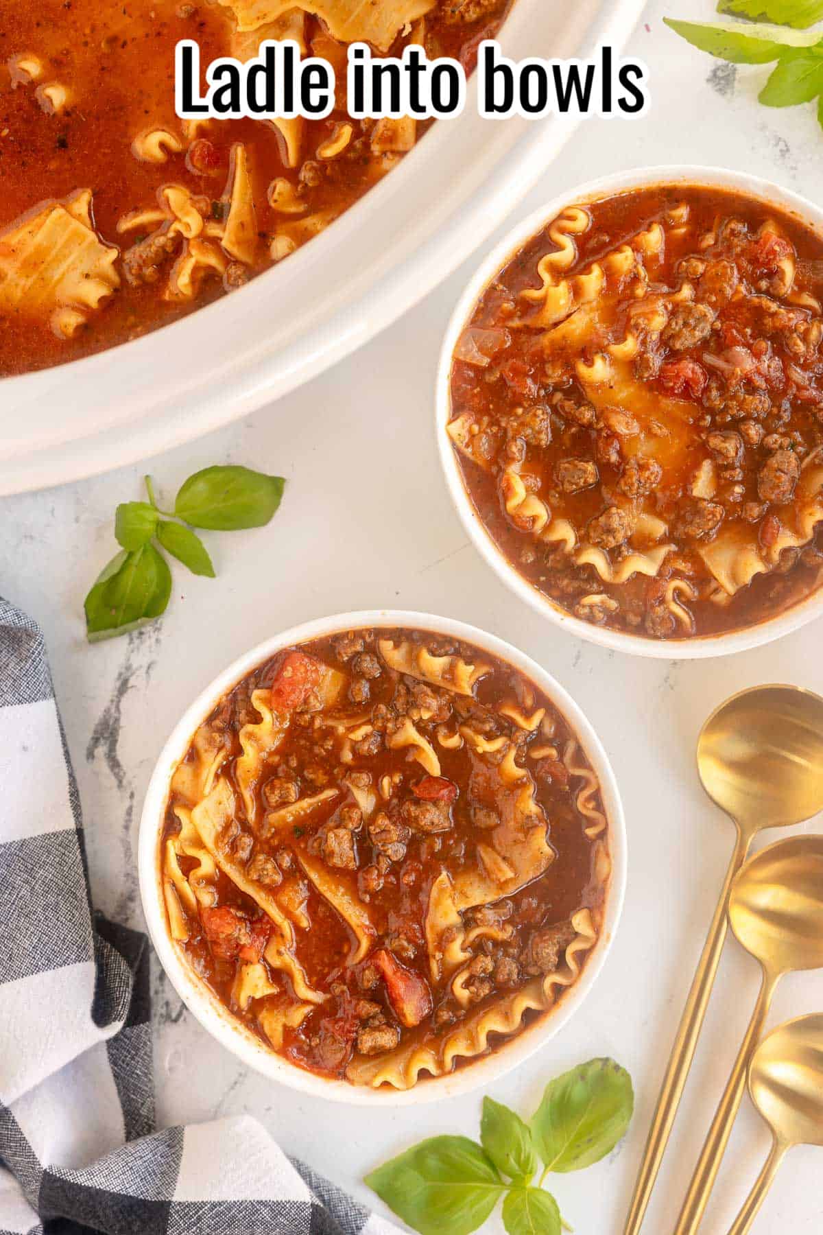 two bowls of soup with 3 gold spoons.