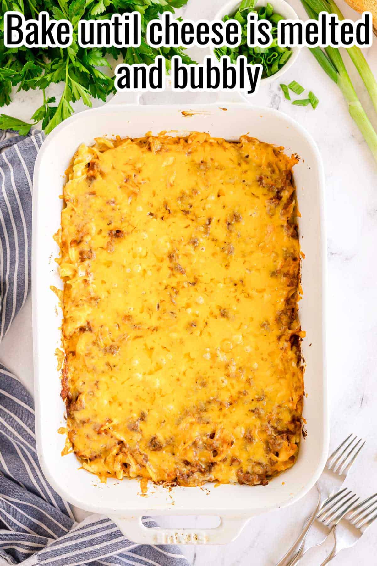 Baked casserole with golden, melted cheese on top. Text on the image says 'Bake until cheese is melted and bubbly'